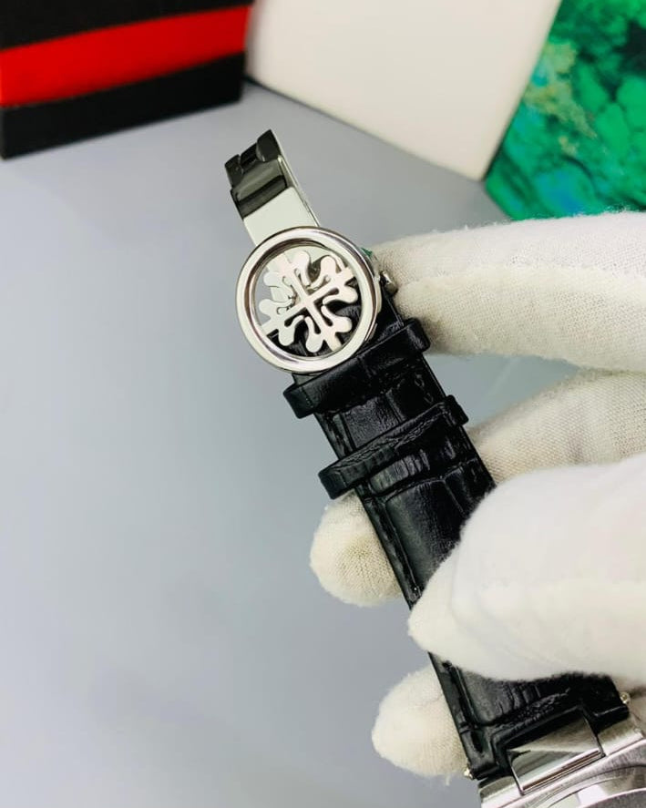 Watch held by a gloved hand with a blurred background