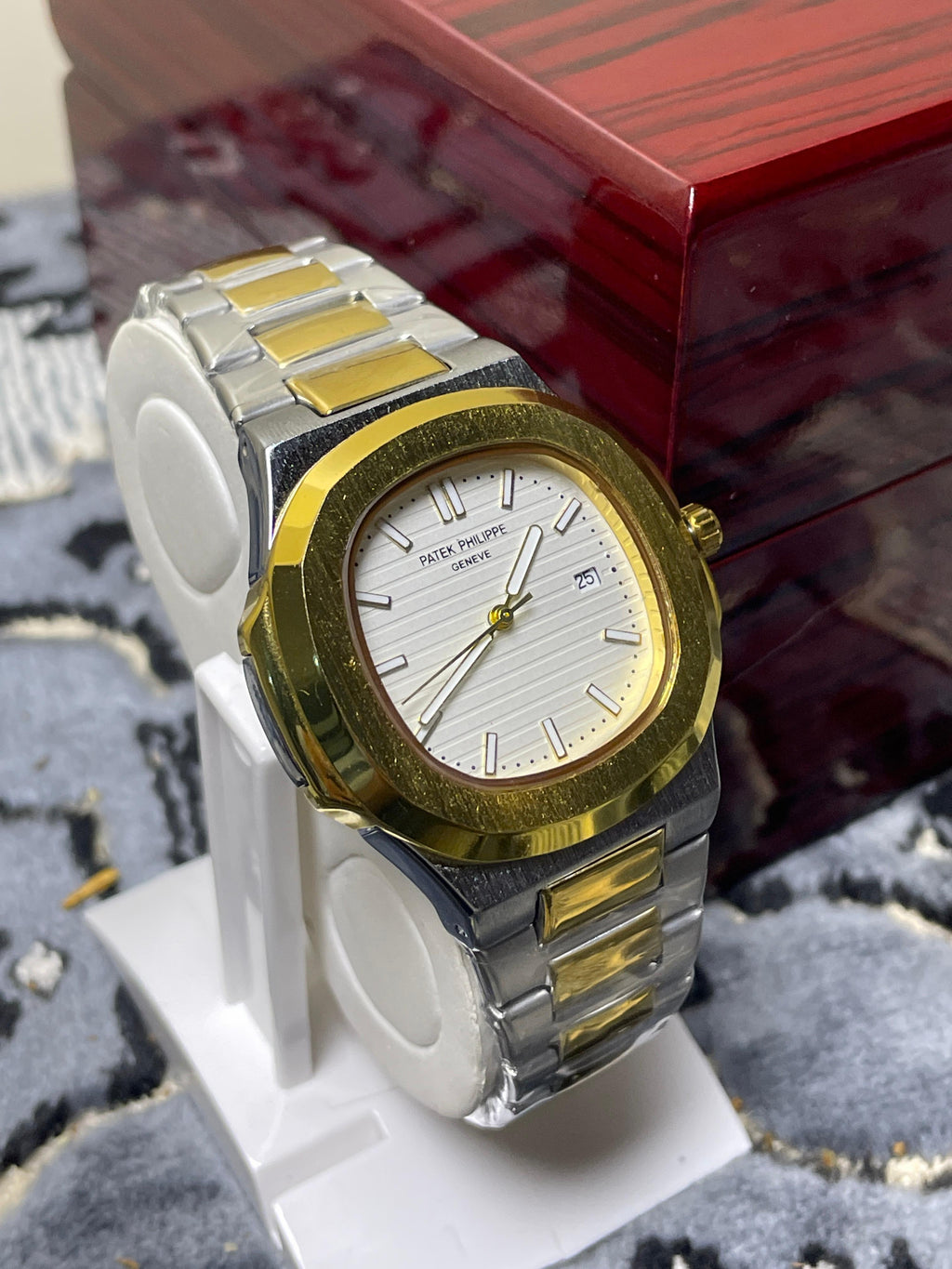 Luxury watch with gold and silver accents on a stand