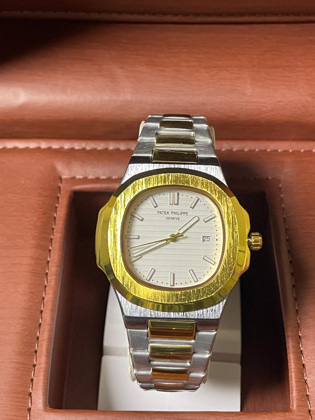 Gold and silver watch in a brown box