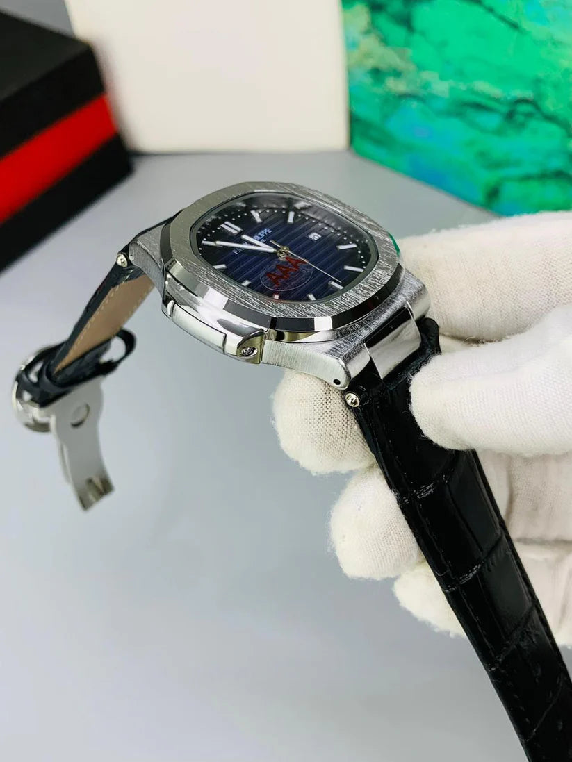 Watch with black leather strap held by white gloves on a light gray background